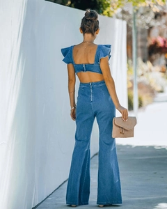Back view of denim set featuring ruffle sleeve open back top and high waist flare pants