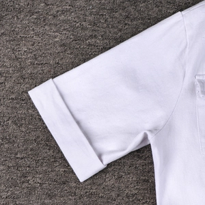 Detailed close-up of folded sleeve cuff on white cotton twill fabric with neat stitching