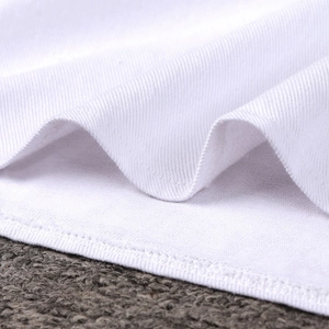 Detailed close-up of white denim fabric showing high-quality double-needle stitching and texture
