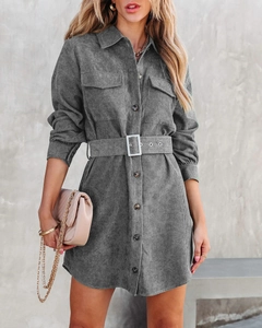 Detail of grey corduroy shirt dress showing textured fabric, belted waist and utility pockets