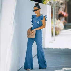 Chic blue denim jumpsuit with ruffle shoulder details and wide leg flared hemline