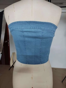 Detail of light blue denim tube top showing vertical seams and fitted back on a mannequin