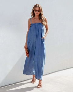 Outdoor shot of light blue denim wide-leg jumpsuit with elasticated tube top design