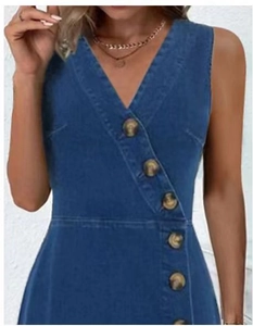 Close-up of V-neck denim dress with tortoise shell buttons and diagonal button placket