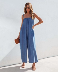 Detail of high waist denim jumpsuit with spaghetti straps and ruffled elastic bodice