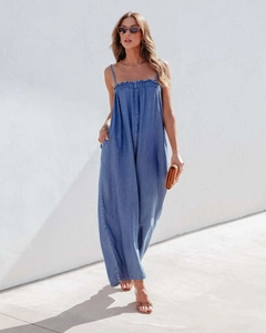 Detailed view of women's denim wide-leg jumpsuit with spaghetti straps and ruched neckline