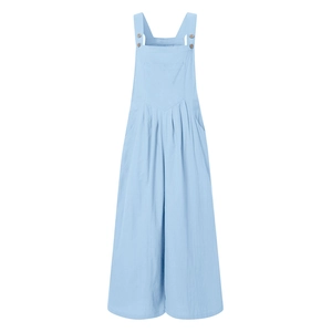 Detail of adjustable wood button straps and front pocket on light blue wide-leg jumpsuit