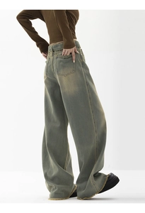 Detail of high-waist wide-leg jeans featuring vintage wash and frayed raw hem design