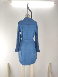 Back view of a long-sleeved denim shirt dress with lapel collar and waist tie details