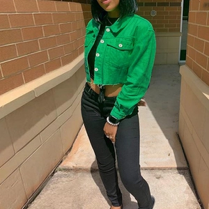 Green cropped denim jacket for women featuring frayed hem and metallic buttons in street style