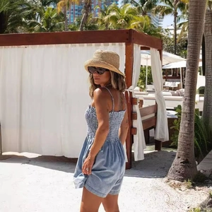 Women summer light blue smocked denim romper with thin straps for beach vacation
