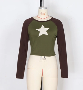 Detail of the stitched star patch and color-block seams on this cropped long sleeve top