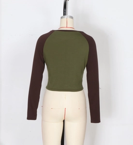 Detail of cropped raglan long sleeve tee in olive green and brown with crew neck