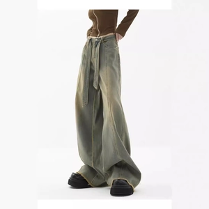 Vintage wash wide leg denim jeans in grey-green with matching belt and frayed hems