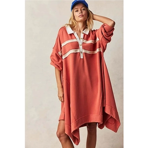 Detailed view of the brick red casual polo dress with white collar and raw edge hem detail