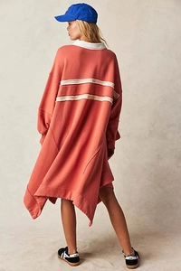 Detail of oversized brick red sweatshirt dress featuring white collar and back stripes