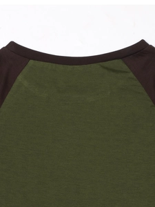Close-up of olive green and brown contrast stitching on the crew neckline of a crop top