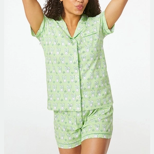 Detail of short sleeve green pajama set featuring white rabbit and heart prints