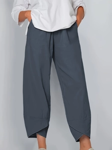 Detail view of charcoal grey cropped pants featuring a unique tulip hem design and elastic waist