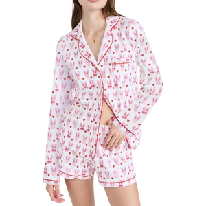 Detailed view of women's pajama set featuring pink rabbit prints and red piping trim