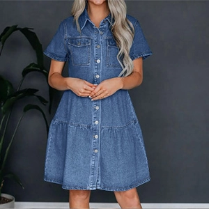 Detail of dark blue denim dress featuring classic collar, metal buttons and chest pockets