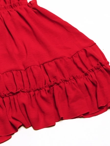 Close-up of red layered ruffle hemline with detailed fabric texture for backless dress