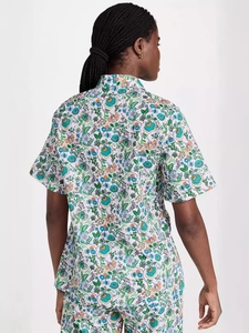 Women's summer two-piece set with vibrant floral print shirt and shorts rear view