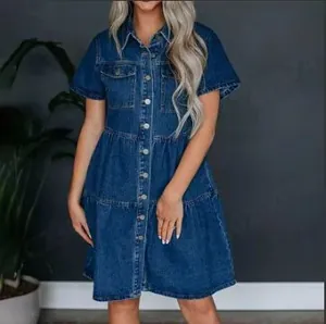 Detail of short-sleeved denim dress featuring a classic collar and layered tiered skirt