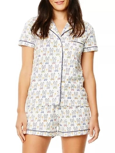 Detail of short pajama set with rabbit print, button-down collar and blue contrast piping