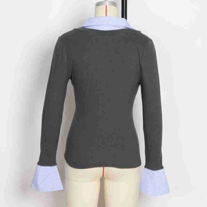 Detailed back view of a grey knit top with blue striped shirt collar and cuffs