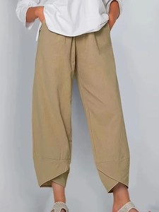 Detail of khaki cropped pants showing cotton-linen texture and tulip hem design