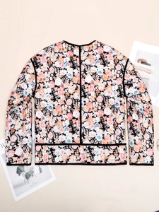Macro shot of floral quilted jacket with colorful patterns and black trim detail