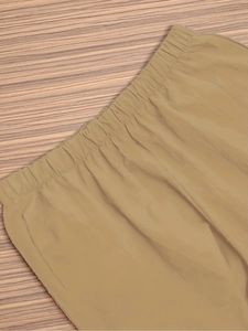 Detail of elastic drawstring waist on khaki stretch trousers with smooth fabric texture