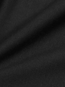 Close-up of premium black knit fabric texture showing fine weave and soft material