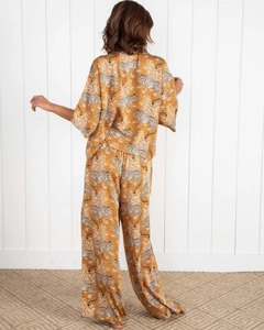 Detail view of the back of a ginger leopard print satin pajama set with wide-leg pants