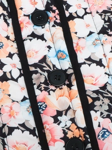 Macro view of floral quilted jacket detailing with black buttons and patterned fabric