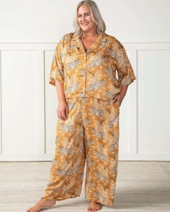 Detail of plus size pajama set with tiger print and soft silk-like fabric in yellow