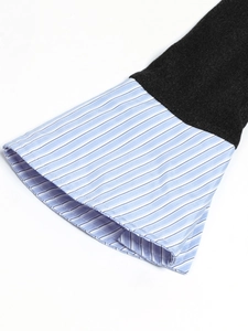 Detail of bell sleeves with black knit fabric and blue-white striped shirt patchwork