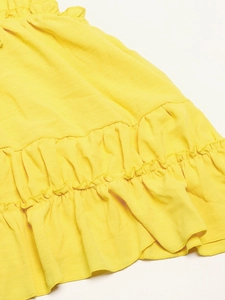 Detail of the layered lemon yellow fabric with cotton texture and ruffle trim hem