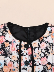 Detail shot of the quilted floral pattern cotton jacket with black binding and round neck