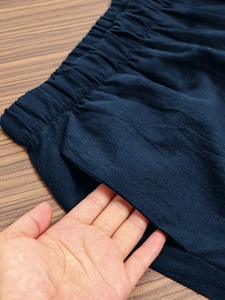 Detail of stretch elastic waistband and deep side pockets on navy casual crop pants