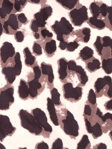 Macro view of leopard print textile fabric with detailed brown and black animal spot pattern