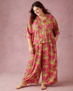 Detail of rose pink pajama set with cheetah and floral prints on silky fabric top and pants