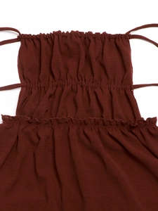 Close-up of wine red ribbed knit dress with smocked ruffles and thin shoulder straps