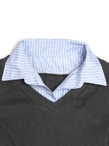 Detailed view of V-neck grey knit top with blue striped shirt collar and fabric texture