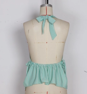 Detail of green striped halter top with back bow tie and ruffled hem on a mannequin