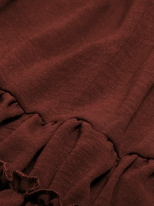 Macro detail of burgundy cotton linen fabric with ruffled texture for summer dress