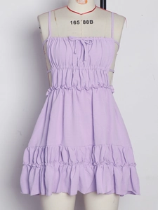 Detail of light purple backless mini dress featuring tiered skirt and bow neckline