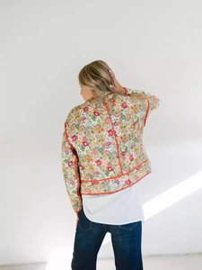 Quilted floral jacket for women with orange piping and vintage flower pattern