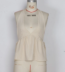 Detail of V-neck striped halter top featuring pleated hem and cotton linen texture